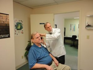 audiologist attending to patient